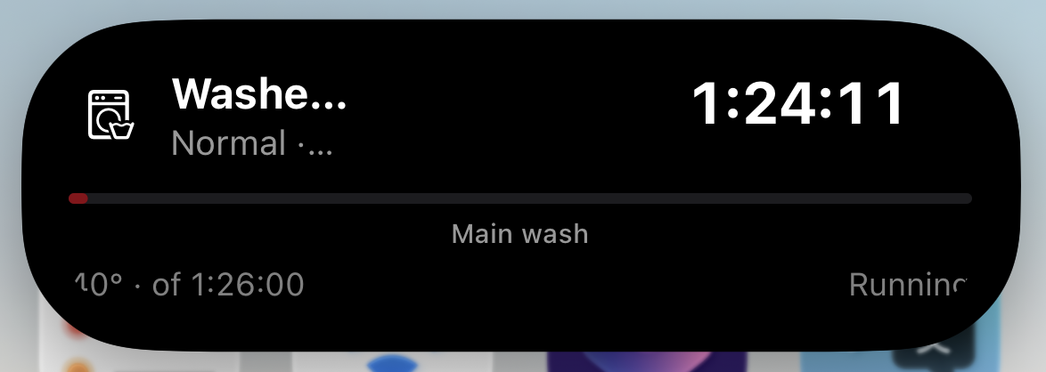 iPhone Dynamic Island expanded, showing the washer program, progress and 1:24:11 remaining.